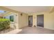 Covered front entry features neutral paint, well-lit entry, and tiled patio area at 4760 Gulf Of Mexico Dr. Villa 7, Longboat Key, FL 34228