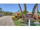 Attractive villas complex with tropical landscaping, well-maintained grounds, and dedicated parking spaces at 4760 Gulf Of Mexico Dr. Villa 7, Longboat Key, FL 34228