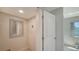 Bright hallway featuring neutral paint, a mirror, and a door leading to an interior room at 4760 Gulf Of Mexico Dr. Villa 7, Longboat Key, FL 34228