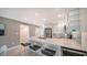 Renovated kitchen featuring stainless steel appliances, bar seating, and sleek backsplash at 4760 Gulf Of Mexico Dr. Villa 7, Longboat Key, FL 34228