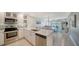 Beautifully updated kitchen with stainless appliances, granite countertops, and open dining area at 4760 Gulf Of Mexico Dr. Villa 7, Longboat Key, FL 34228