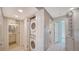 Conveniently located laundry room with stacked washer and dryer and storage at 4760 Gulf Of Mexico Dr. Villa 7, Longboat Key, FL 34228