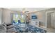 Comfortable living area with sliding glass doors to outdoor patio with garden view at 4760 Gulf Of Mexico Dr. Villa 7, Longboat Key, FL 34228