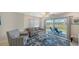 Comfortable living room featuring a couch, armchair, rug, and view of the outdoor patio at 4760 Gulf Of Mexico Dr. Villa 7, Longboat Key, FL 34228