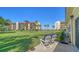 Relaxing patio with comfortable chairs overlooking the lush lawn and tropical landscaping towards the ocean at 4760 Gulf Of Mexico Dr. Villa 7, Longboat Key, FL 34228