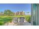 Beautiful patio with seating overlooking a green lawn and palm trees on a sunny day at 4760 Gulf Of Mexico Dr. Villa 7, Longboat Key, FL 34228