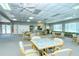 Bright community recreation room with ample seating, ceiling fans, and a kitchenette at 4760 Gulf Of Mexico Dr. Villa 7, Longboat Key, FL 34228