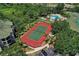 Aerial shot of a community tennis court surrounded by trees and a pool area at 5180 Northridge Rd # 312, Sarasota, FL 34238