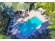 Aerial view of pool surrounded by lounge chairs and green pergola area perfect for relaxation at 5180 Northridge Rd # 312, Sarasota, FL 34238