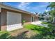 Outdoor space with lush green grass, white door, and a covered patio area at 5209 26Th W Ave, Bradenton, FL 34209