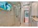 Updated bathroom showcasing a glass-enclosed shower and a unique stained glass window detail at 5209 26Th W Ave, Bradenton, FL 34209