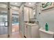 Stylish bathroom with coastal decor, white cabinets, and a view of the pool at 5209 26Th W Ave, Bradenton, FL 34209