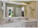 Bathroom boasts double sinks, vanity with a large mirror, and bright modern lighting at 5209 26Th W Ave, Bradenton, FL 34209