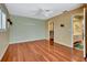 Spacious bedroom with hardwood floors, a ceiling fan, walk-in closet, and attached bathroom at 5209 26Th W Ave, Bradenton, FL 34209