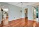 Bright bedroom features wood floors, ceiling fan, walk-in closet, and an en suite bathroom at 5209 26Th W Ave, Bradenton, FL 34209
