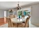 Bright dining room with a view of the pool and a beautiful chandelier at 5209 26Th W Ave, Bradenton, FL 34209