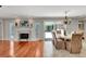 Elegant dining room featuring a fireplace, hardwood floors, and access to the outdoor patio at 5209 26Th W Ave, Bradenton, FL 34209