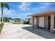 Exterior shot showcasing the driveway leading to a two-car garage and a white door at 5209 26Th W Ave, Bradenton, FL 34209