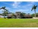 Single-story home featuring lush landscaping, mature palm trees, and a welcoming front entrance at 5209 26Th W Ave, Bradenton, FL 34209
