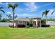 Charming single-story home featuring well-maintained landscaping, tropical palm trees, and a welcoming front entrance at 5209 26Th W Ave, Bradenton, FL 34209