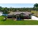 Beautifully landscaped single-story home with a paver driveway and colorful plants enhancing curb appeal at 5209 26Th W Ave, Bradenton, FL 34209