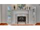 Close up of the decorative fireplace featuring a white mantle and adjacent shutters at 5209 26Th W Ave, Bradenton, FL 34209