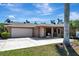 Exterior view featuring a two car garage, driveway, and well-maintained landscaping at 5209 26Th W Ave, Bradenton, FL 34209