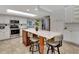 Kitchen island with seating and skylight offers a functional layout with modern stainless steel appliances at 5209 26Th W Ave, Bradenton, FL 34209