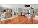 Open-concept living space with hardwood floors, ceiling fans, and seamless flow to kitchen at 5209 26Th W Ave, Bradenton, FL 34209