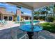 Outdoor patio offers an exquisite space, a pool, and scenic lush greenery at 5209 26Th W Ave, Bradenton, FL 34209