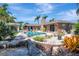 Inviting pool area with lush landscaping, a serene rock pond, and a covered patio, perfect for outdoor enjoyment at 5209 26Th W Ave, Bradenton, FL 34209
