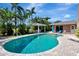 A beautiful swimming pool with an outdoor cabana provides a serene spot in the lush, tropical backyard at 5209 26Th W Ave, Bradenton, FL 34209