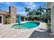 A lovely backyard swimming pool surrounded by lush greenery and a paver patio, perfect for outdoor enjoyment at 5209 26Th W Ave, Bradenton, FL 34209