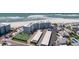 Aerial view showcasing the beachfront condo, parking, and tennis court at 5300 Gulf Dr # 204, Holmes Beach, FL 34217