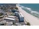 Stunning aerial view of beachfront condos, tennis court, and pristine sandy beach at 5300 Gulf Dr # 204, Holmes Beach, FL 34217