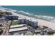 Aerial view of condominium on beach with tennis court, storage units and parking at 5300 Gulf Dr # 204, Holmes Beach, FL 34217