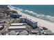 Wide shot of beach condos overlooking a tennis court, storage units, and other residences at 5300 Gulf Dr # 204, Holmes Beach, FL 34217