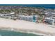 An elevated perspective of condos, a tennis court, a pool, and direct beach access at 5300 Gulf Dr # 204, Holmes Beach, FL 34217