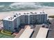 Full aerial shot of condos showing the balconies and on-site parking and beach access at 5300 Gulf Dr # 204, Holmes Beach, FL 34217