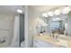 Bathroom with large mirror and granite countertops and shower and tub combo at 5300 Gulf Dr # 204, Holmes Beach, FL 34217