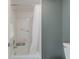 Bright white bathroom with shower-tub combo, grab bar and neutral wall color at 5300 Gulf Dr # 204, Holmes Beach, FL 34217