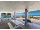 Beachside community lounge with a picnic table, chairs, and ocean views near the pool at 5300 Gulf Dr # 204, Holmes Beach, FL 34217