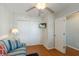 Bright bedroom with a comfortable couch, ceiling fan, closet, and a wall-mounted television at 5300 Gulf Dr # 204, Holmes Beach, FL 34217