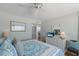 Bright bedroom features coastal decor, dresser, and ceiling fan for relaxed beach living at 5300 Gulf Dr # 204, Holmes Beach, FL 34217