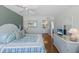 Comfortable bedroom with beach-themed decor, light wood floors, and bathroom access at 5300 Gulf Dr # 204, Holmes Beach, FL 34217