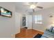 Bright bedroom with a ceiling fan, comfortable couch, closet, and a wall-mounted television at 5300 Gulf Dr # 204, Holmes Beach, FL 34217