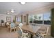Bright dining room with wicker furniture and view of the well-maintained landscaping outside the window at 5300 Gulf Dr # 204, Holmes Beach, FL 34217