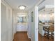 Hallway featuring bathroom and kitchen with granite countertops, stainless steel appliances, and tile backsplash at 5300 Gulf Dr # 204, Holmes Beach, FL 34217