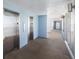 Well-lit hallway with elevators and exterior access at 5300 Gulf Dr # 204, Holmes Beach, FL 34217