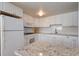 Charming kitchen featuring white cabinetry, granite countertops, and modern appliances at 5300 Gulf Dr # 204, Holmes Beach, FL 34217